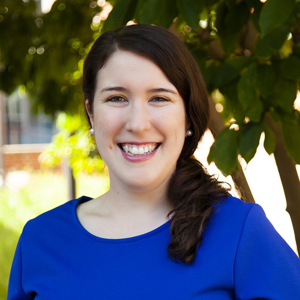 Sarah Jean Barton is a middle-aged white woman with long brown hair and a blue shirt.