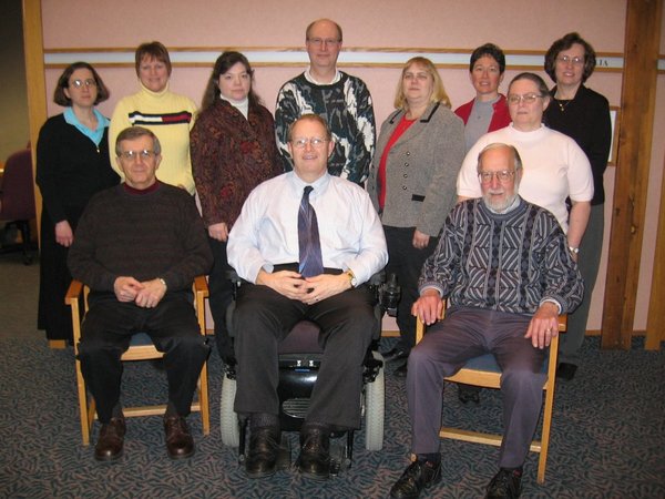 The first ADN board of directors: eleven white adults of varying ages and abilities.