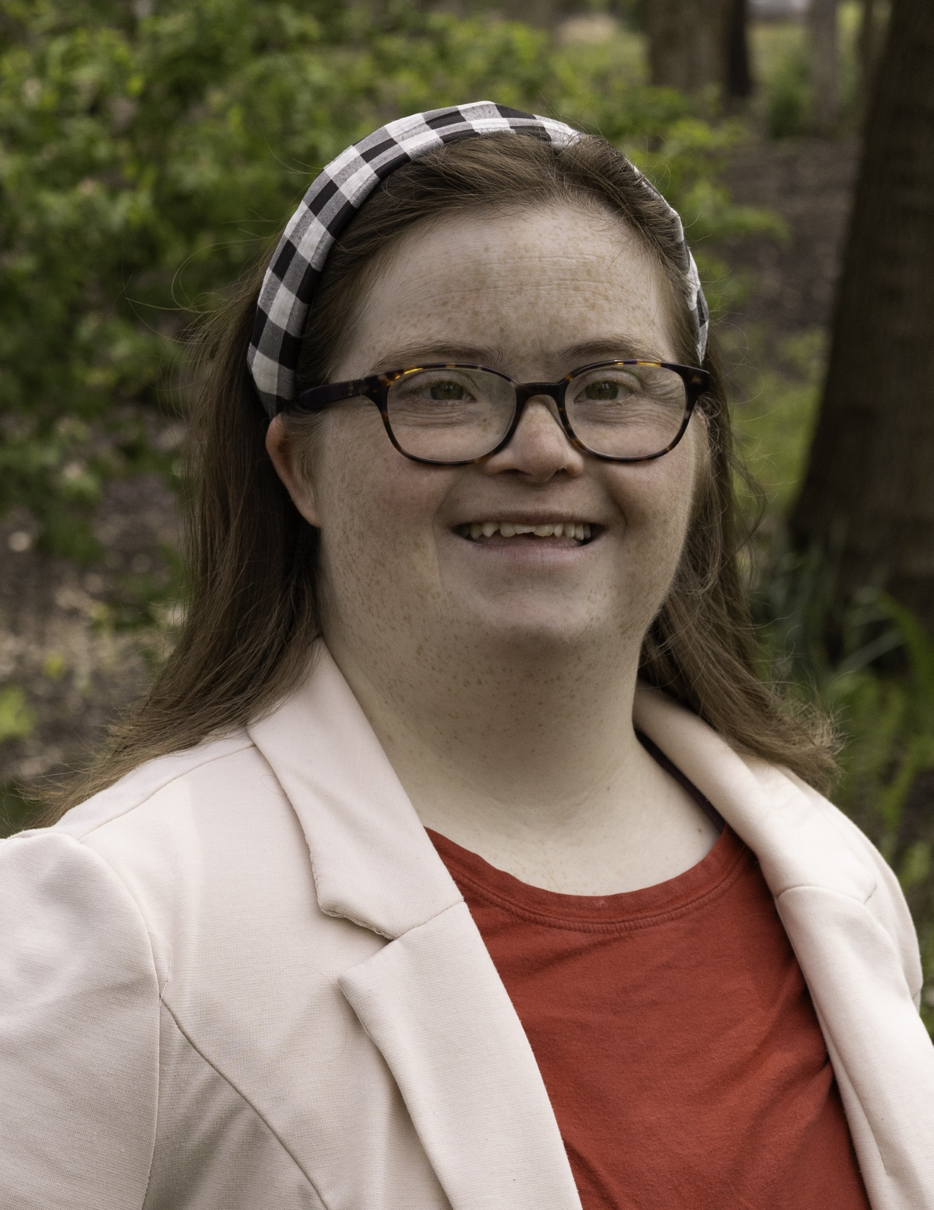 Emily Krabill is a young adult white female with long brown hair. She has visible signs of down syndrome.