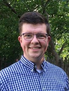 Mitch Stutzman is a young adult white male wearing a collared shirt standing outside.