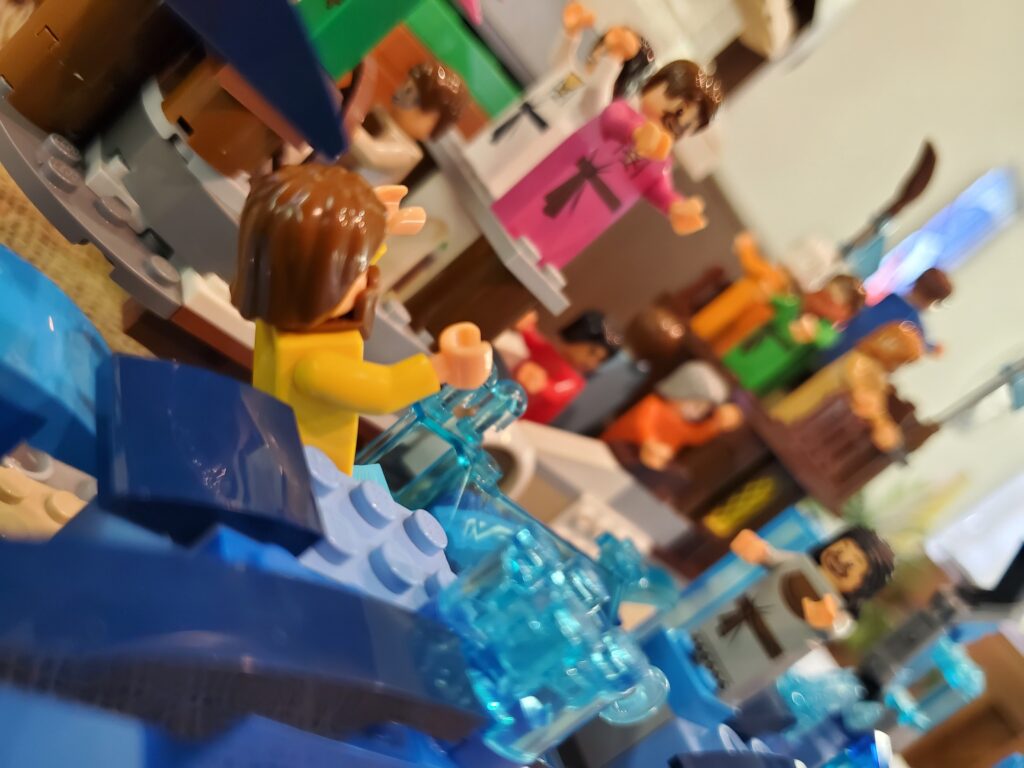 Lego sculpture of Peter walking towards Jesus on water.