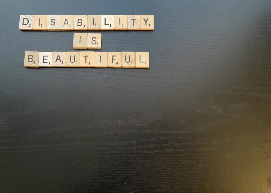 scrabble tiles spell out "Disability is Beautiful"