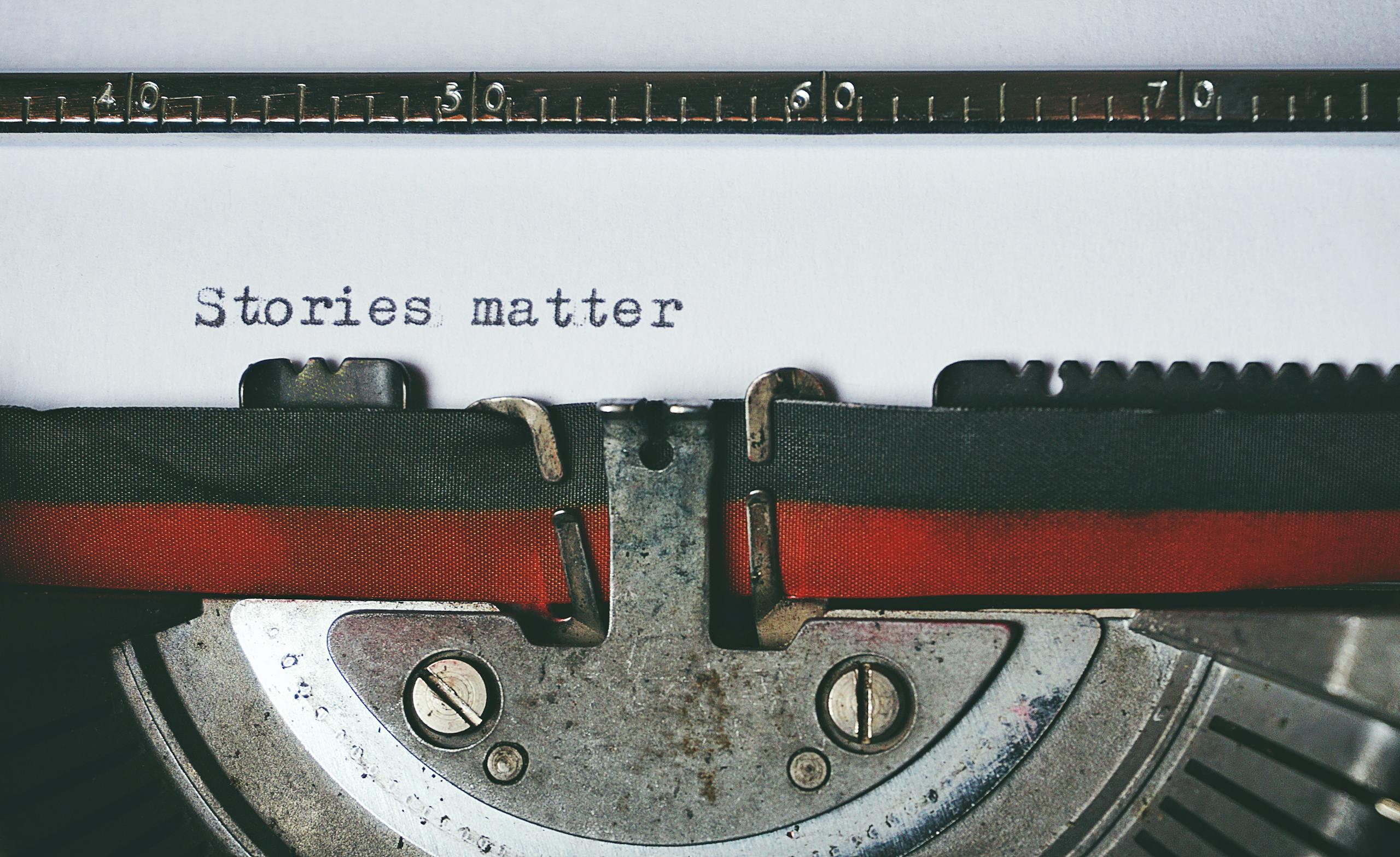 Black and Red Typewriter with a page that says "Stories Matter."