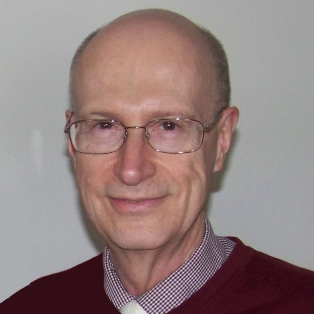 Older white man, clean shaven, with glasses