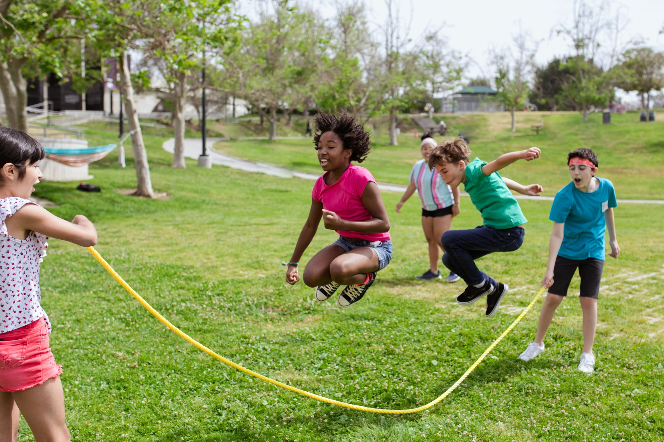 children of various ethnicities and genders jumping rope