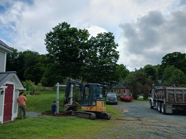 a backhoe digs a hole in a hill.